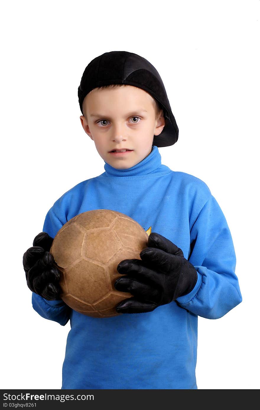 The boy with a ball in gloves a black cap. The boy with a ball in gloves a black cap.