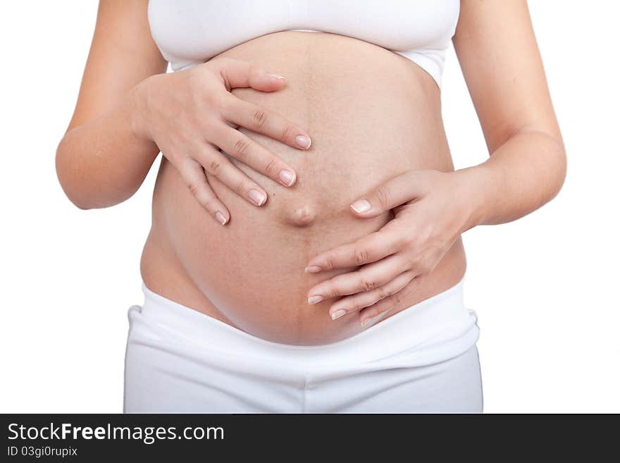 Pregnant woman hold hands on a belly isolated