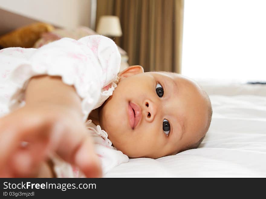 Cute asian ethnic baby girl lay on bed. Cute asian ethnic baby girl lay on bed