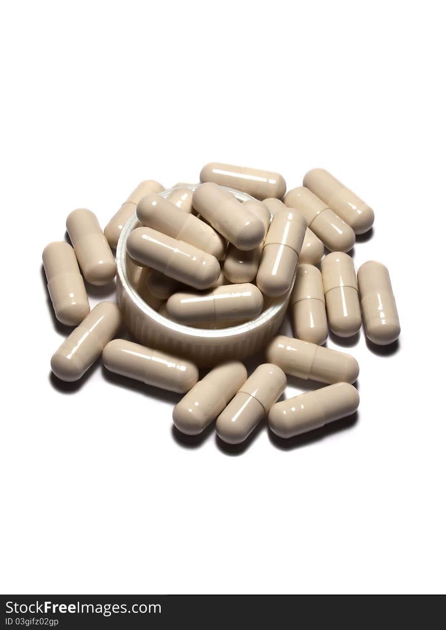 Many White capsules on Plastic lid with Isolated white background.