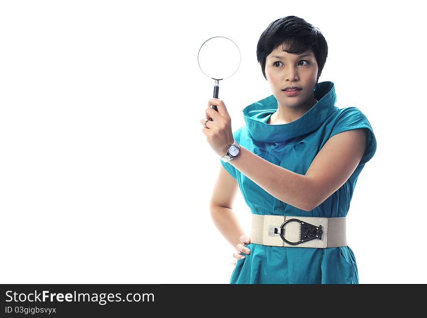 A women in green suite with magnifier in hand in isolated white background