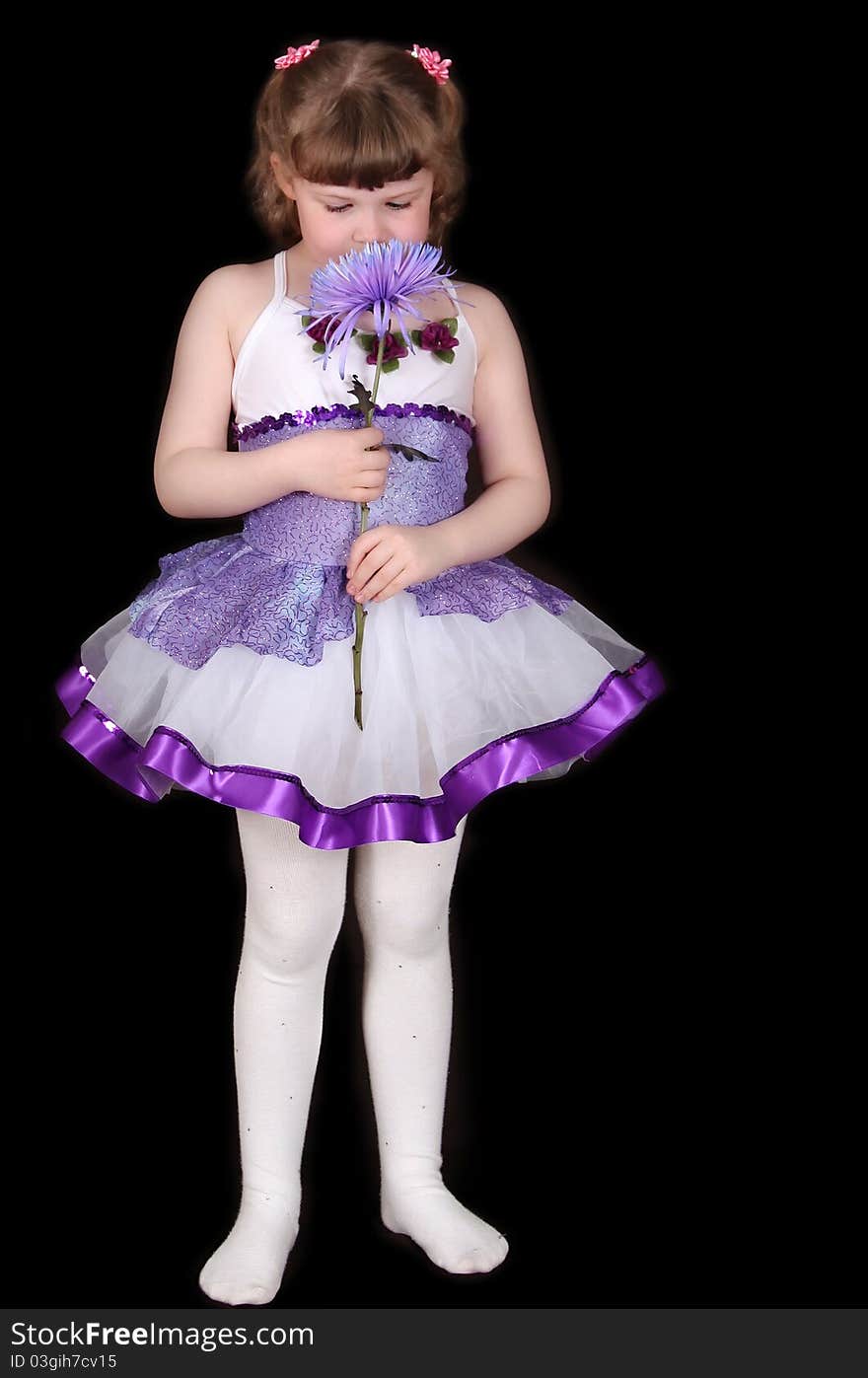 Little Girl In Tutu Smelling Flower. Isolated