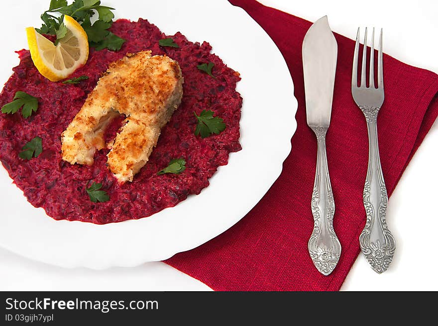 Fish stake with beet sauce, lemon and parsley on the white background. Fish stake with beet sauce, lemon and parsley on the white background