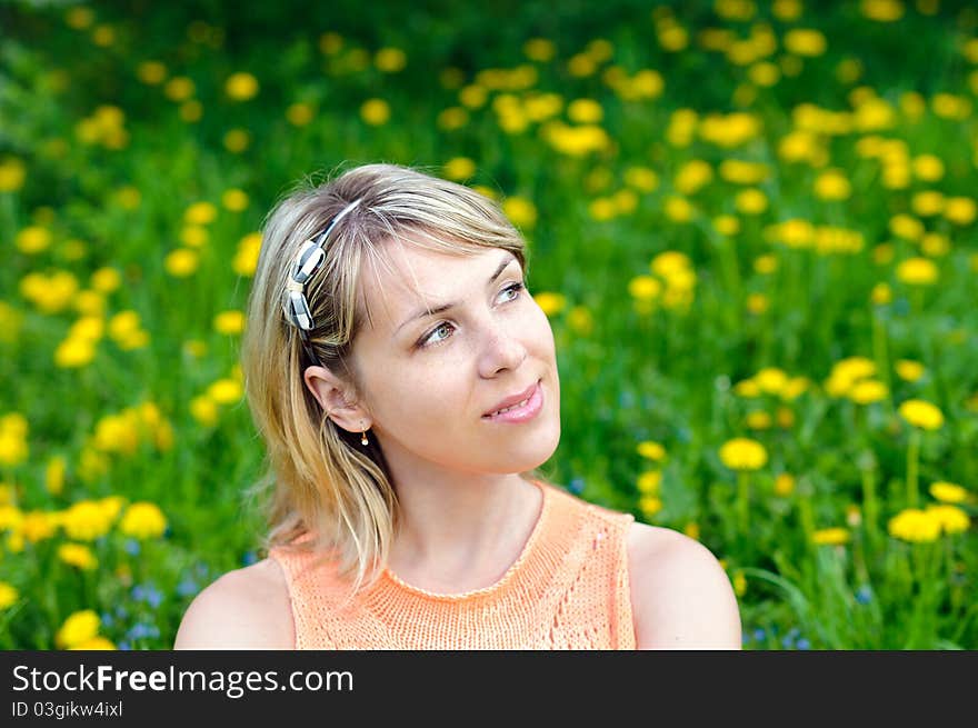 Portrait of a young woman on the grass background. Portrait of a young woman on the grass background