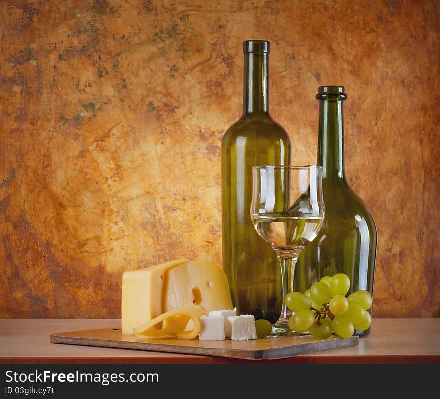 White wine with different sorts of cheese