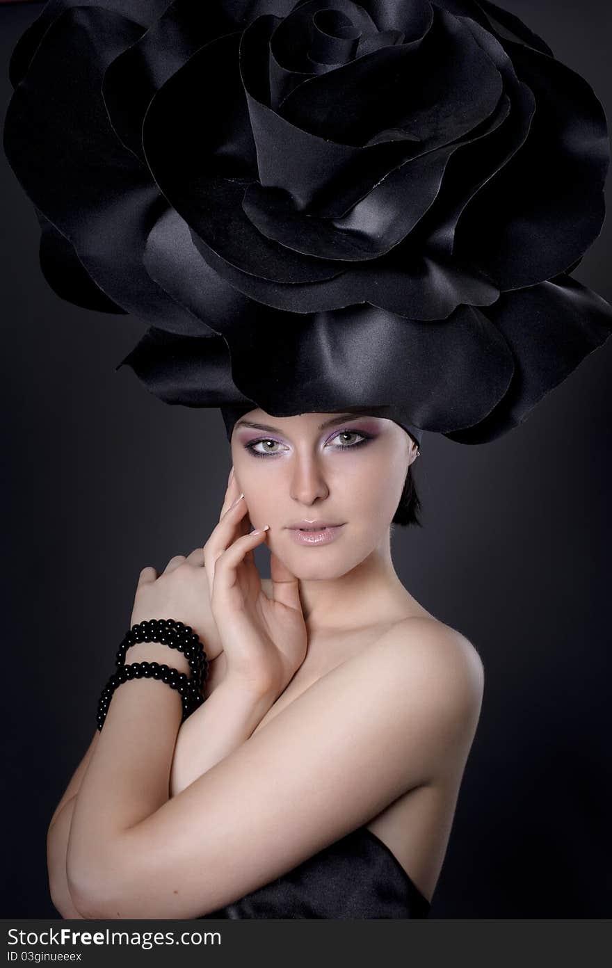 Dark portrait of a girl in a dark roses suit