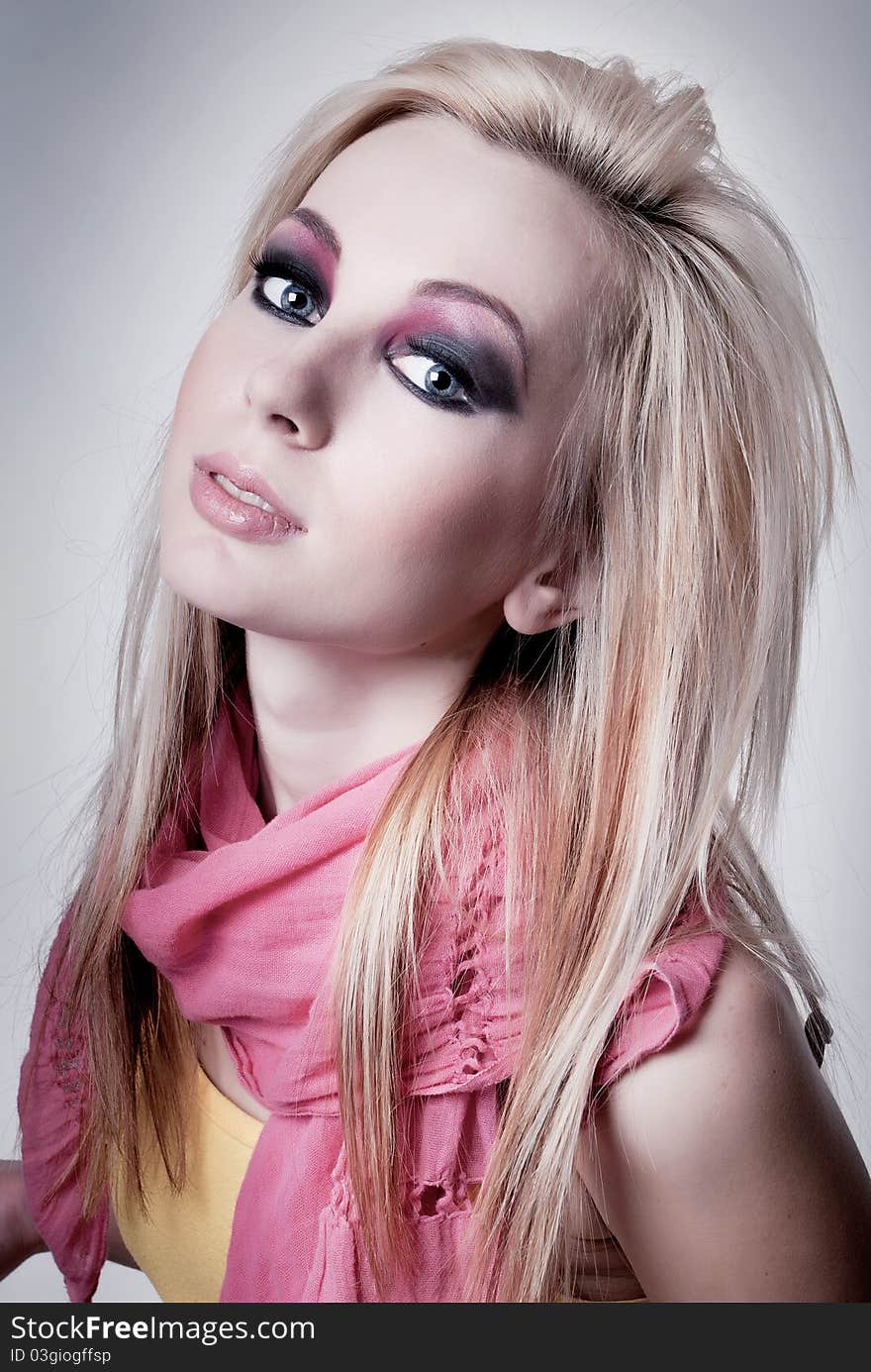 Close up portrait of a young blonde girl with bright makeup