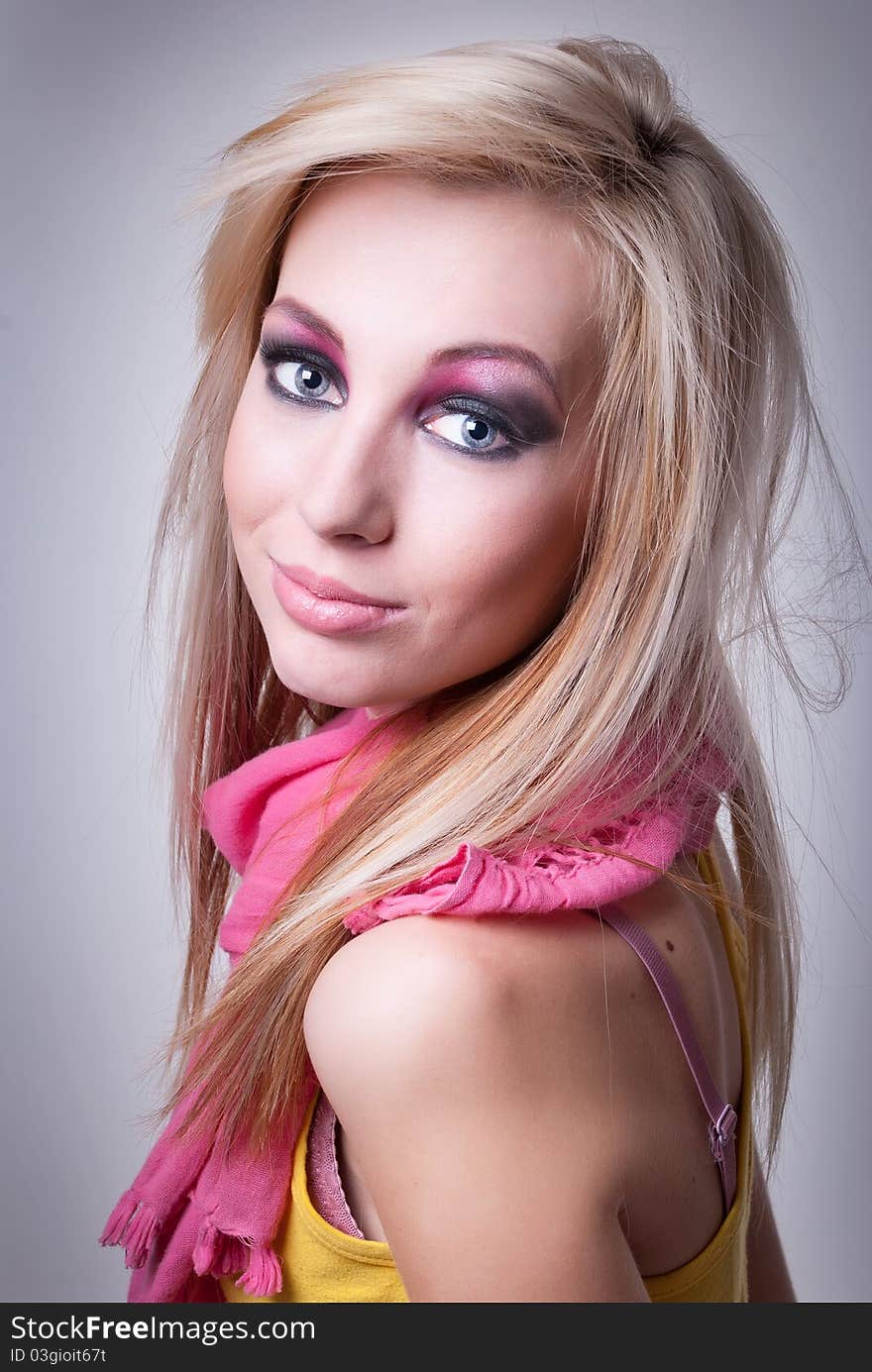 Close up portrait of a young blonde girl with bright makeup