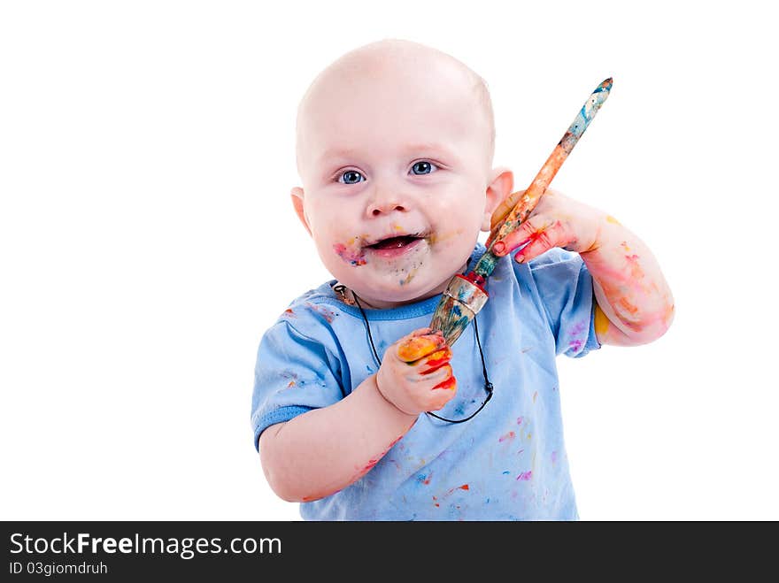 Portrait of a cheerful grimy kid. playing with paint. on a white studio background.