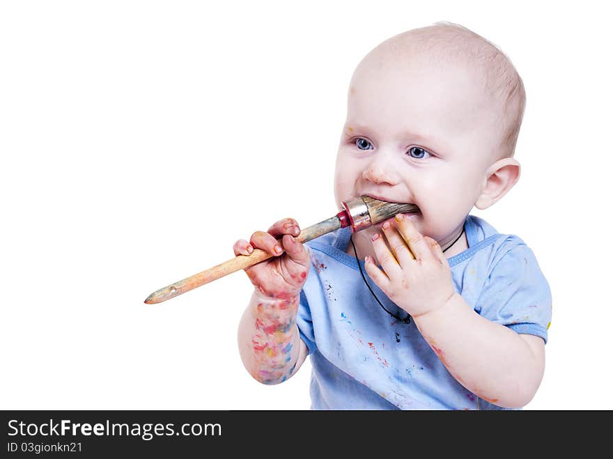 Portrait of a cheerful grimy kid. playing with paint. on a white studio background.