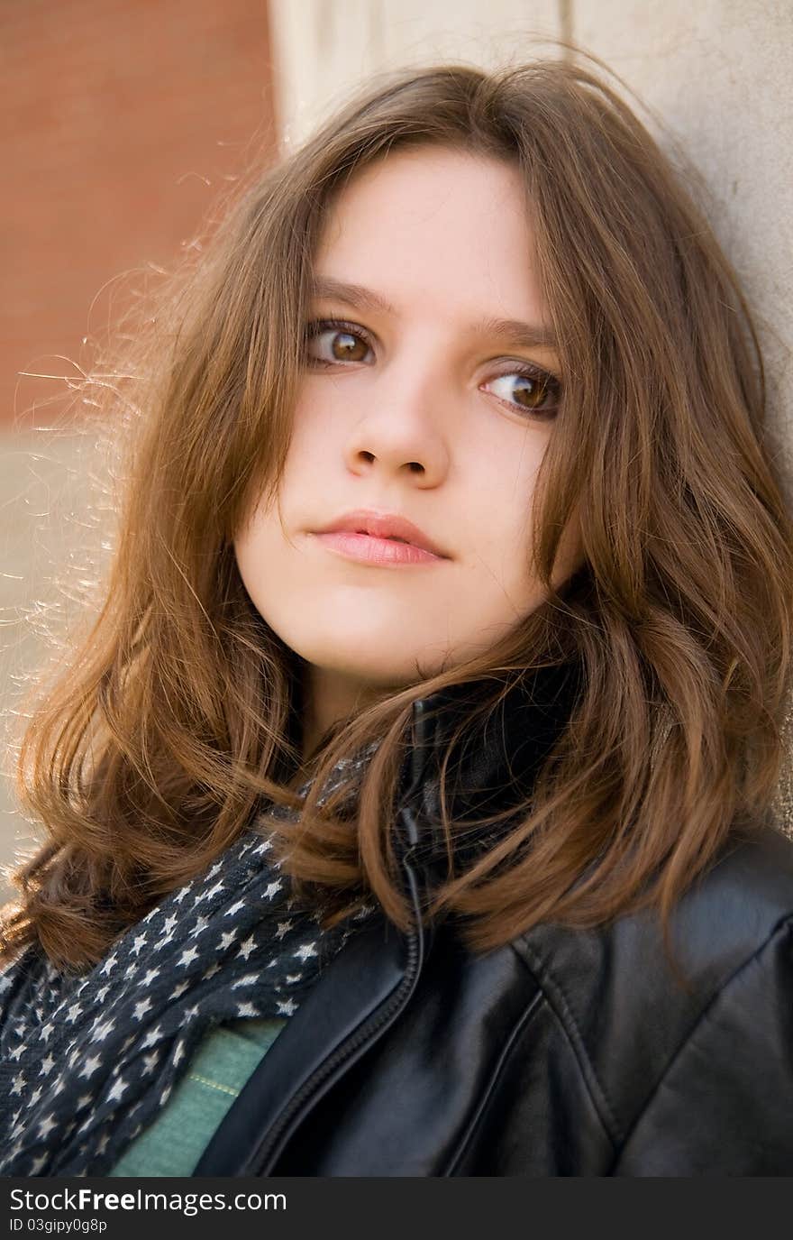 Teenage girl on a brick background