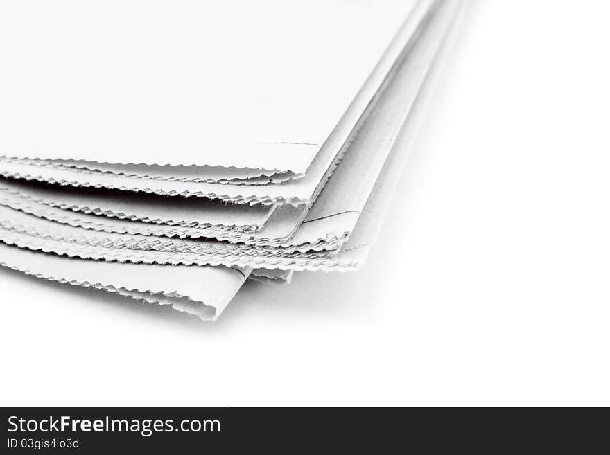 Corner of stack of newspaper over white background. Corner of stack of newspaper over white background