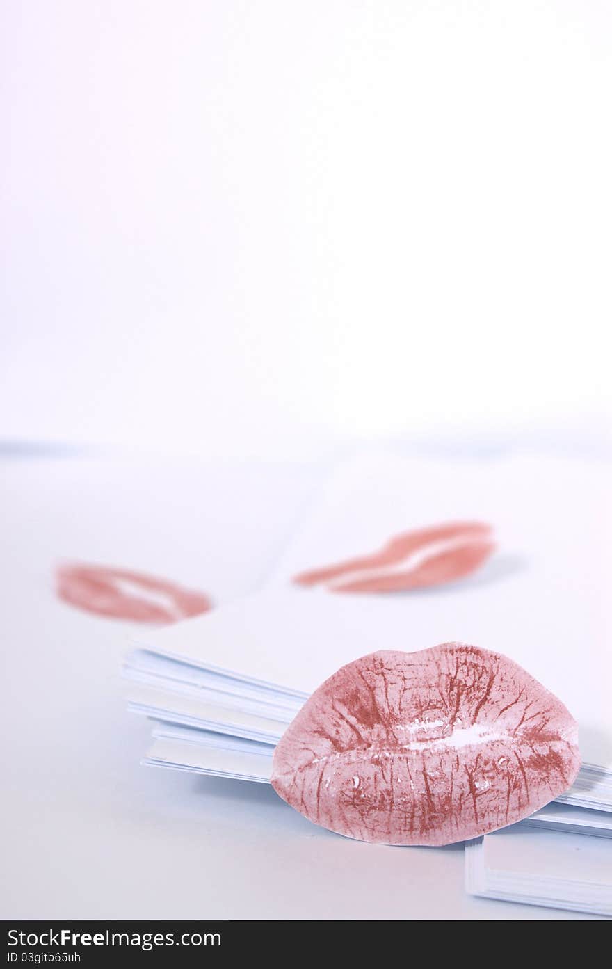 Red lip prints on the paper stack