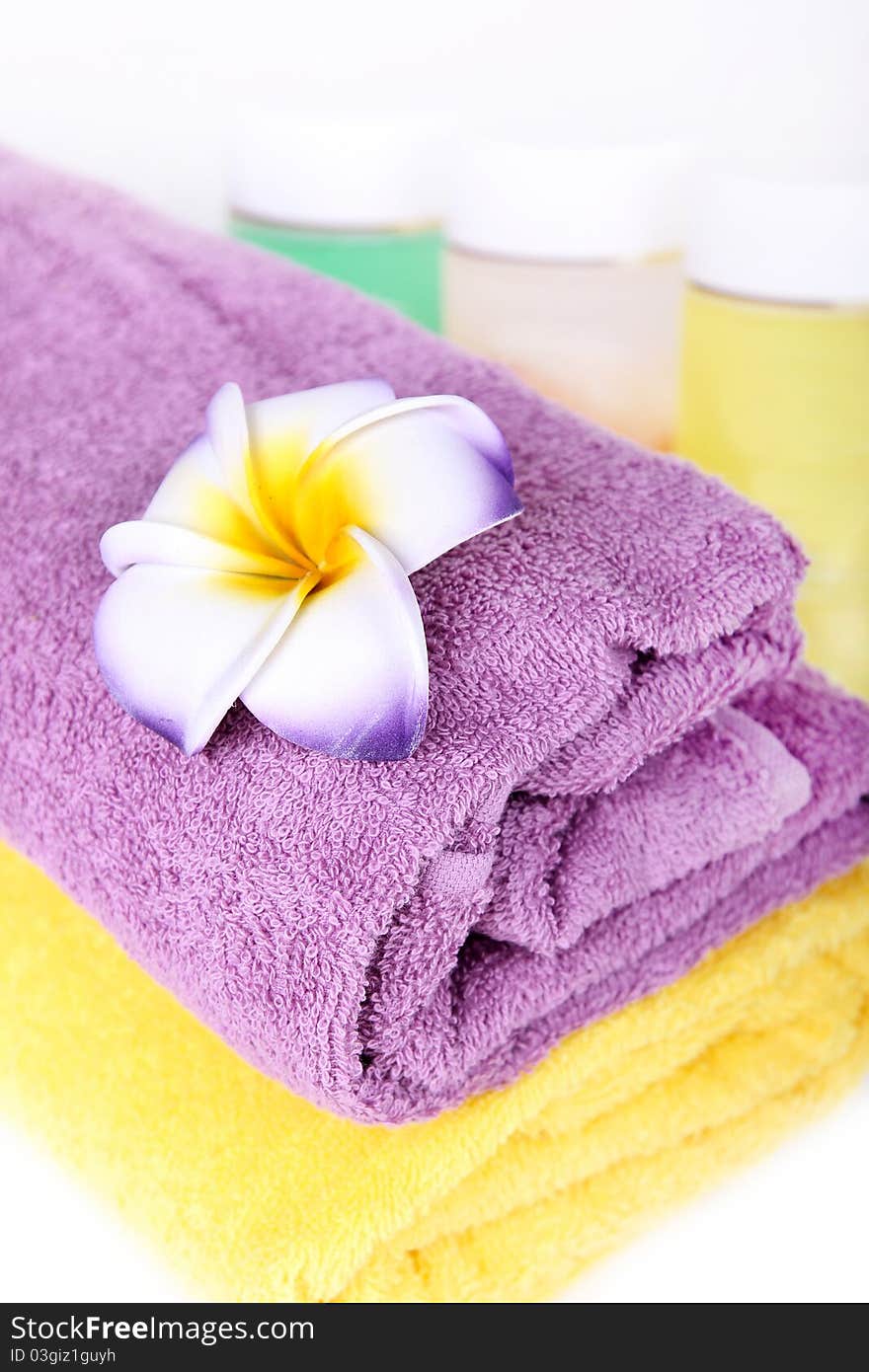 Towels, flower and cosmetics. Beauty spa concept. Towels, flower and cosmetics. Beauty spa concept