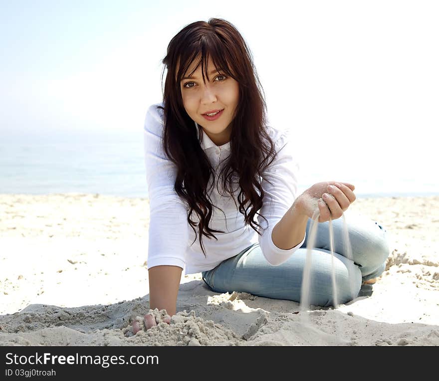 Brunette girl at the beach in spring time.