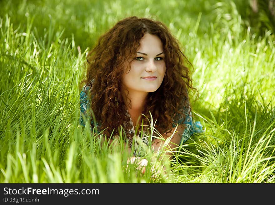 Redhead girl at green grass