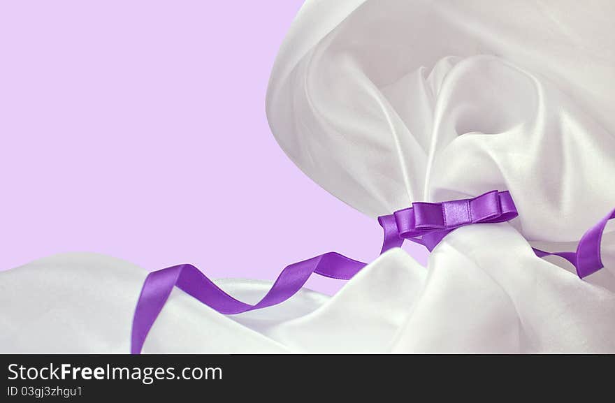 Violet holiday ribbon bow on background. Violet holiday ribbon bow on background