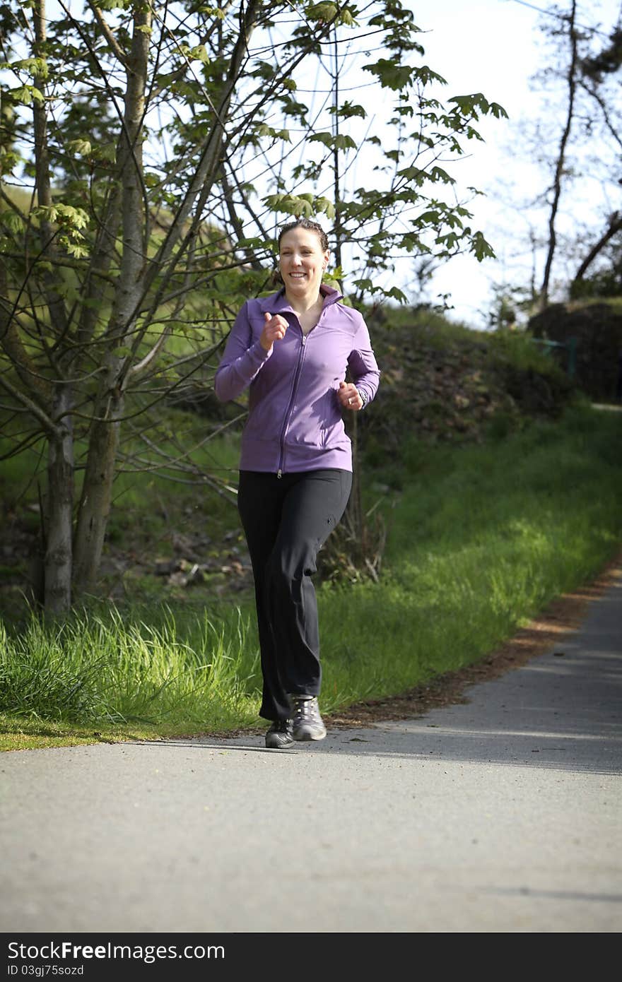 Women in sportswear jogging in a park. Women in sportswear jogging in a park