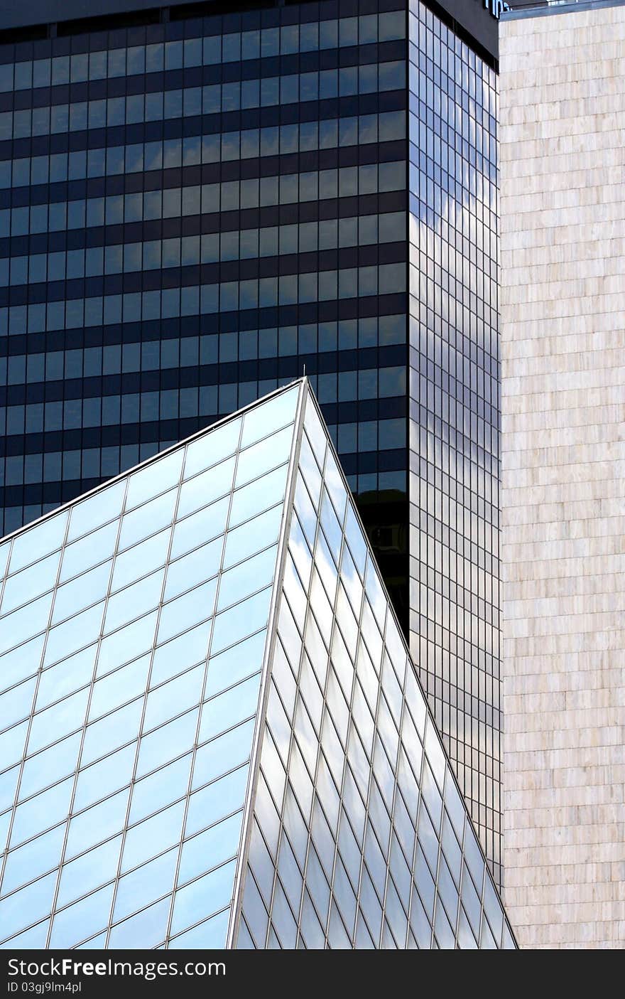 Blue pyramid-shaped architecture. Office towers in background. Blue pyramid-shaped architecture. Office towers in background.