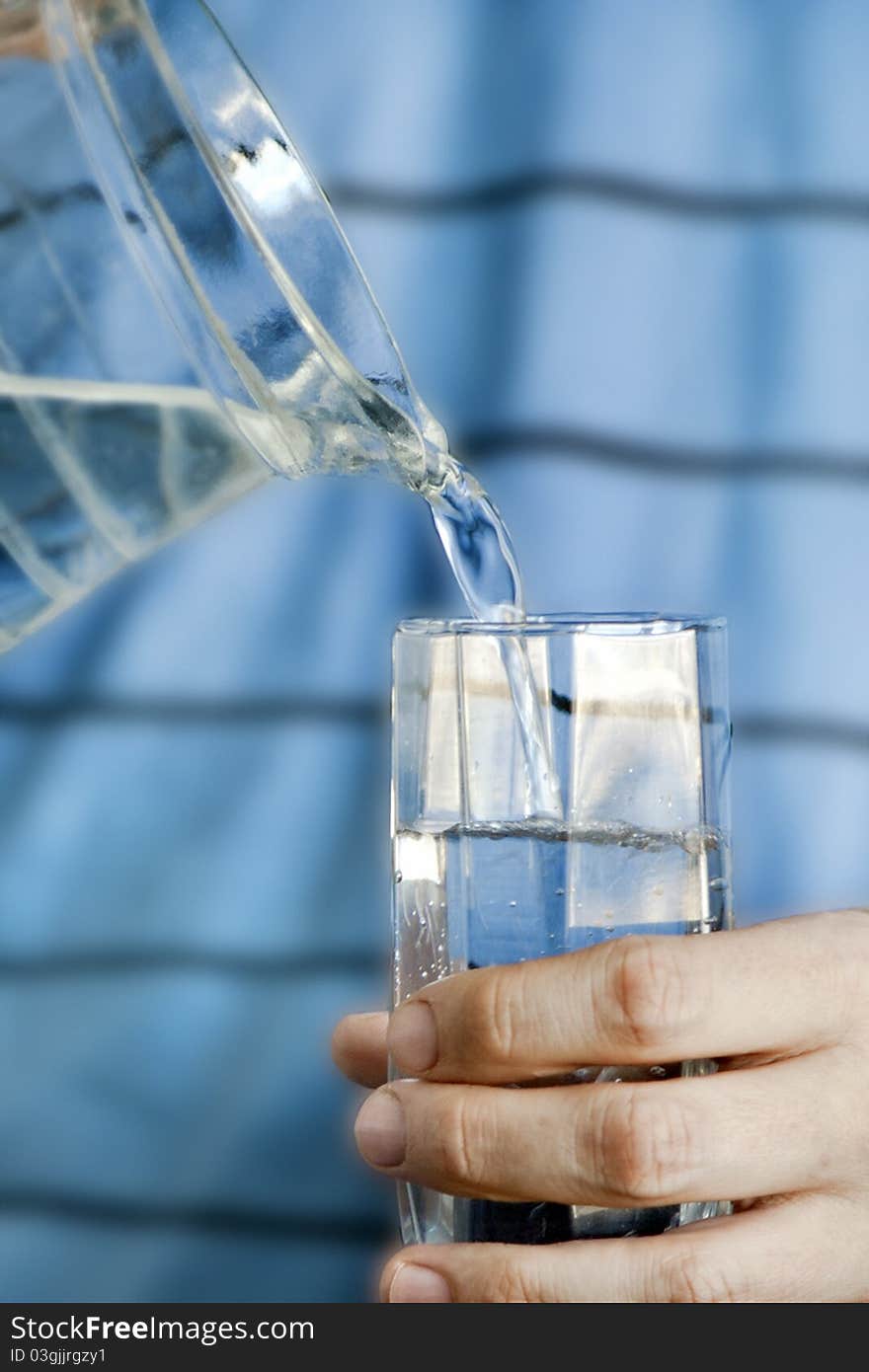 Men's hand giving a glass of fresh water. Men's hand giving a glass of fresh water.