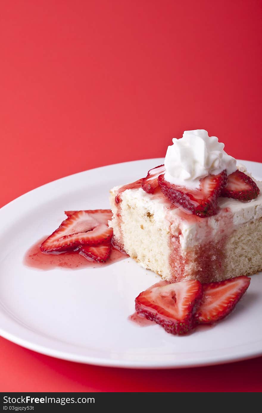 Strawberry shortcake on a red background sliced berries and whipped cream