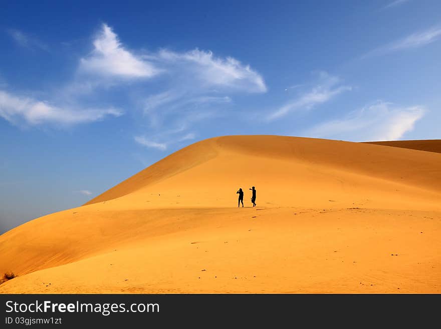 Photo of sand dunes with travellers. Photo of sand dunes with travellers