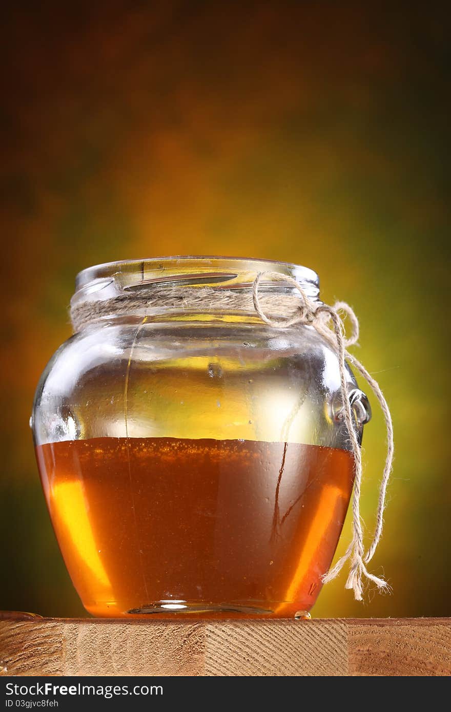 Pot of honey on a table.