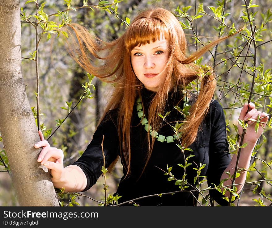 Portrait of the young woman with developing hair