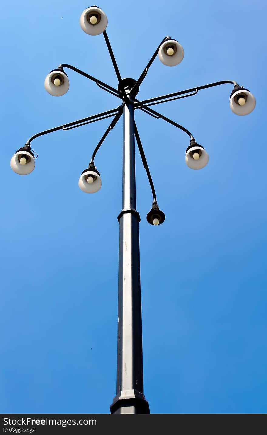 A lamppost with white lamp