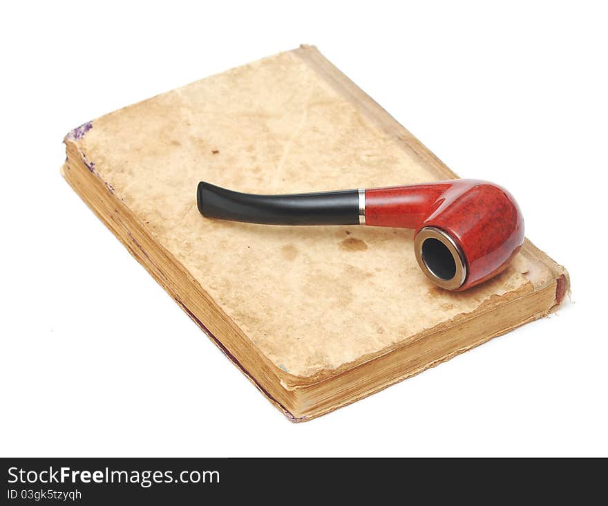 Old book with vintage pipe on white. Old book with vintage pipe on white