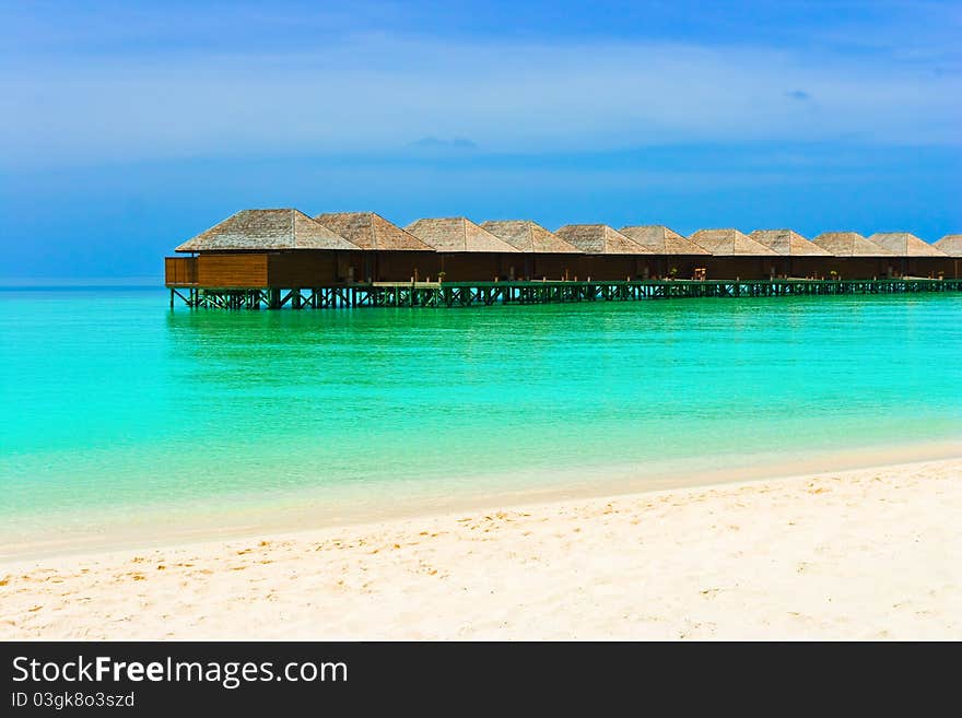 Water bungalows on a tropical island - travel background