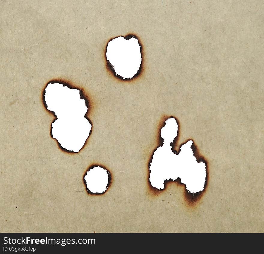 Holes burned in old paper