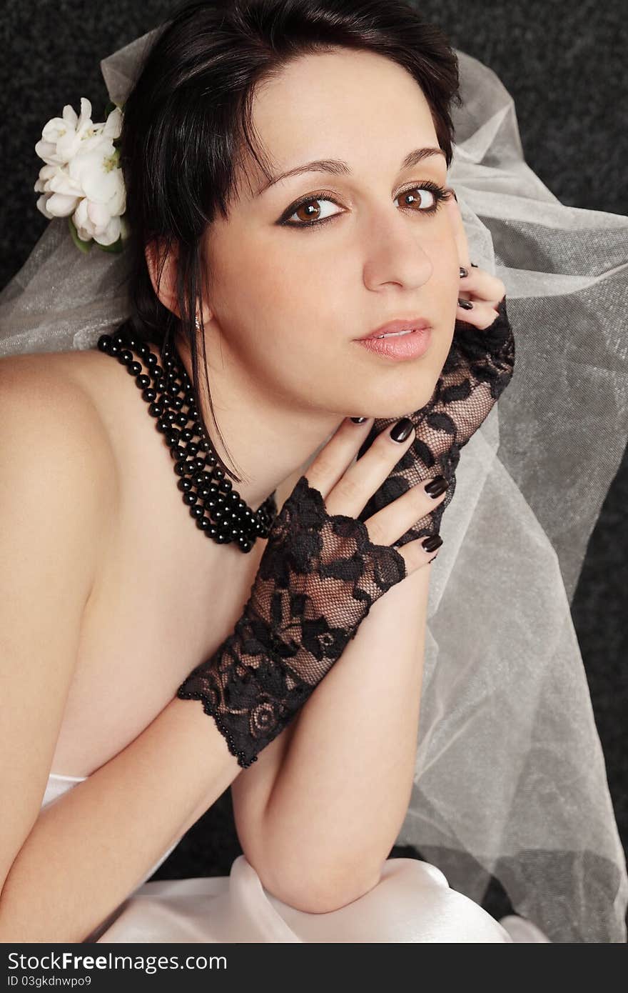 Beautiful young bride in the black gloves