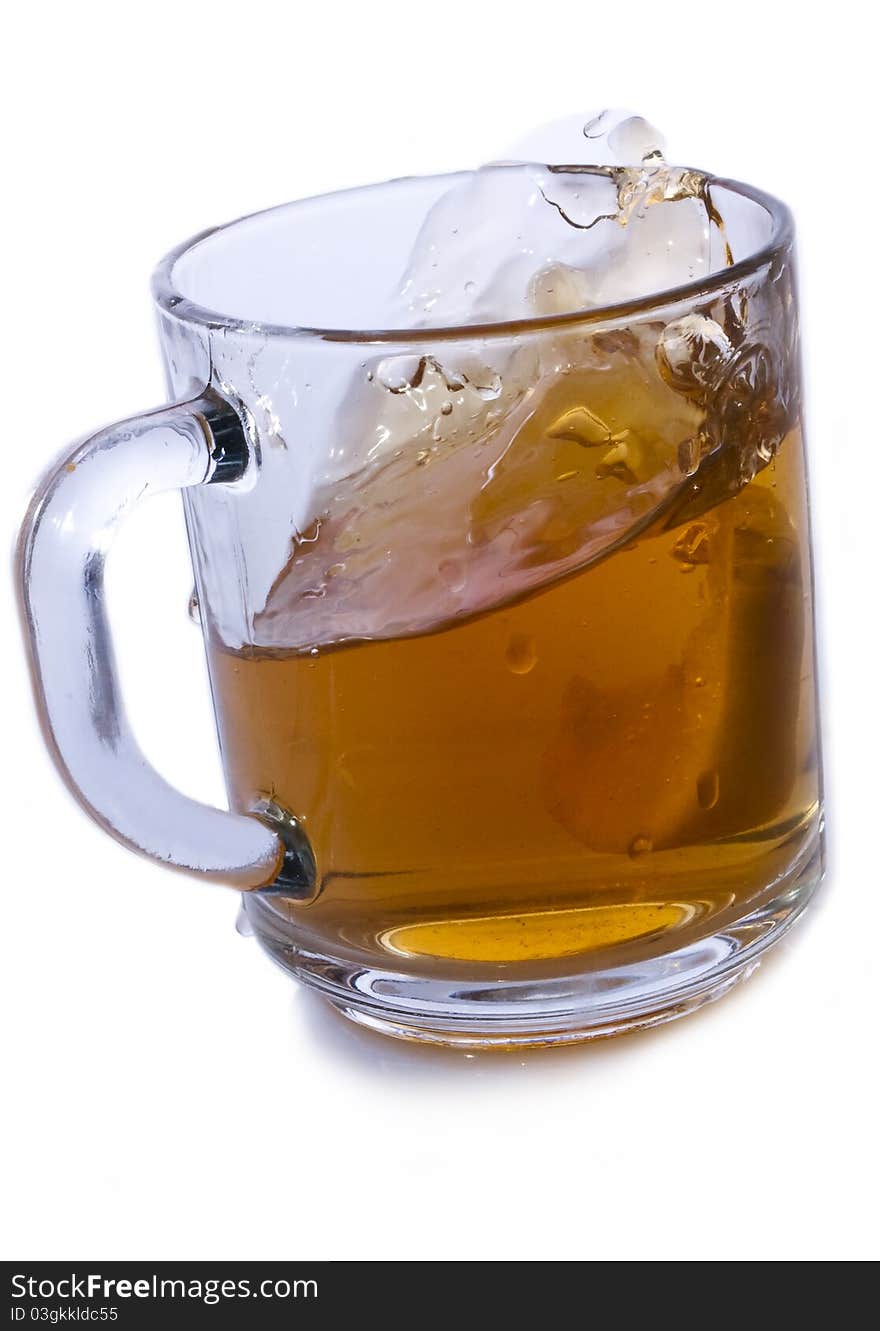 Glass cup of tea with lemon on a white background