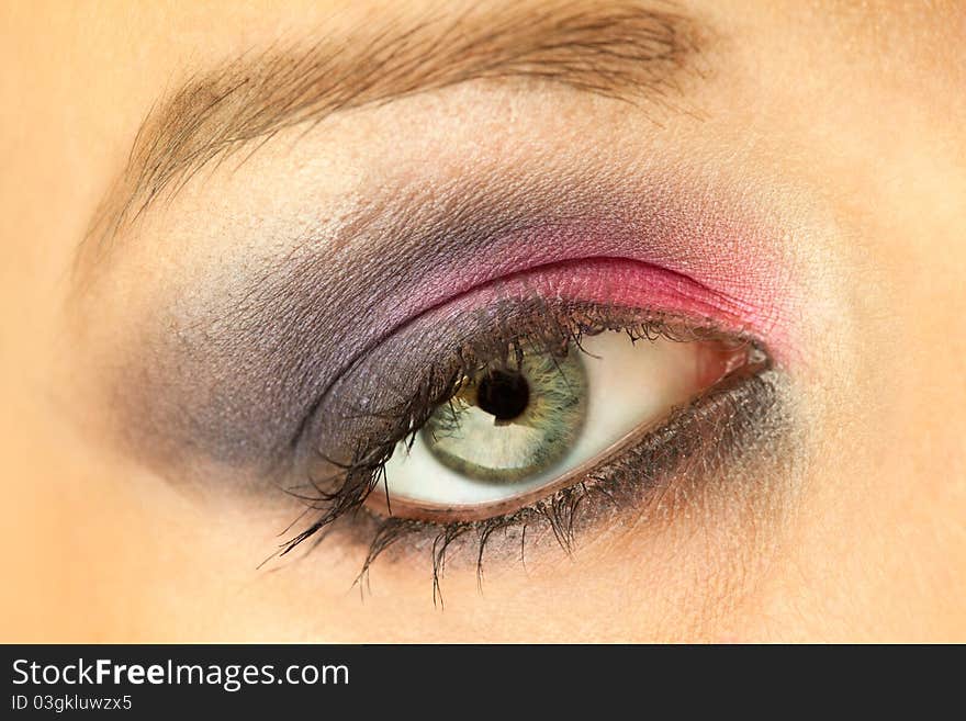 Close-up of woman eye with ceremonial bright make-up