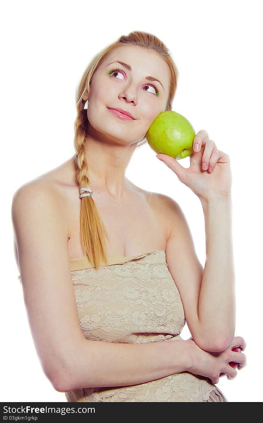 Portrait of young woman with green apple