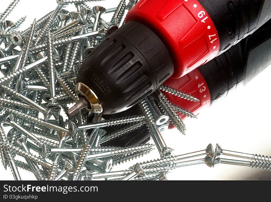 Screwdriver with unscrewing screws on white background. Screwdriver with unscrewing screws on white background