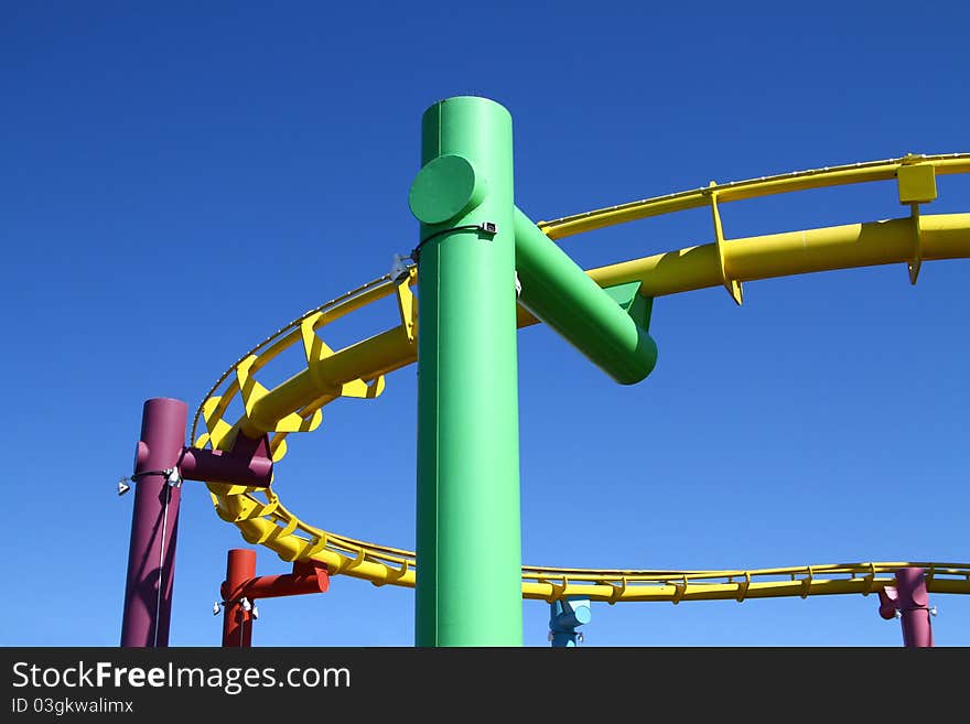 Colourful roller coaster turn on blue sky. Colourful roller coaster turn on blue sky