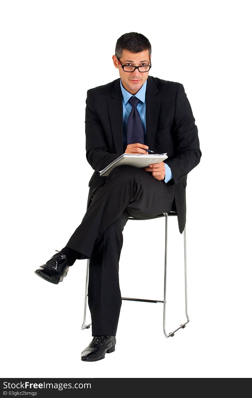 Sitting businessman with eyeglasses writing in white background