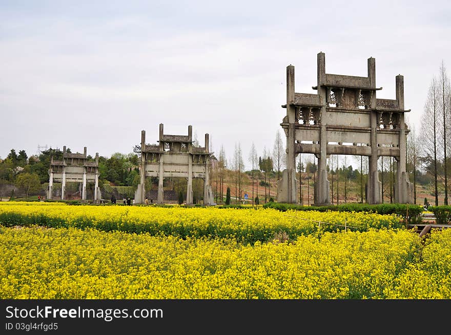 Landmark of Chinese ancient Memorial Archway in the blooming rapeseed fields. Landmark of Chinese ancient Memorial Archway in the blooming rapeseed fields