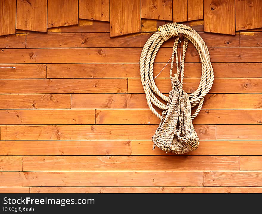 Orange old texture of wooden boards with ship rope.