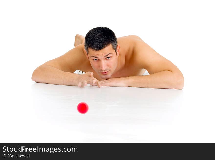 Bare-chested man lying on the floor playing with m