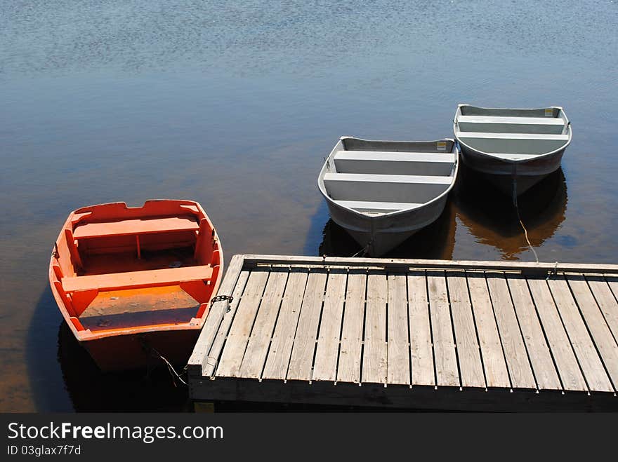 Three boats at a dock in the ocean in Maine. Three boats at a dock in the ocean in Maine