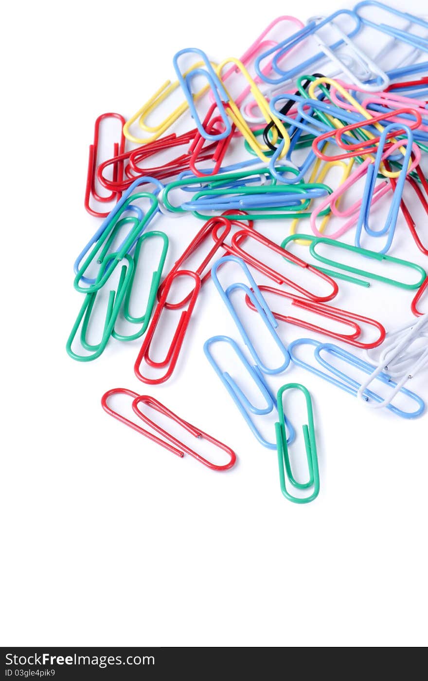 Closeup of multi-colored paper clips on white