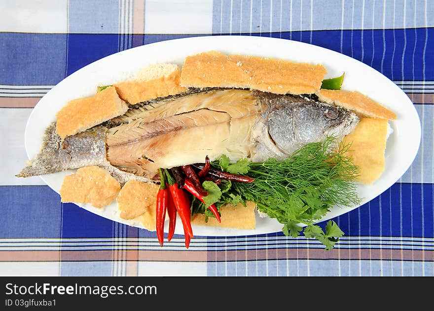 Whole fried bass on plate