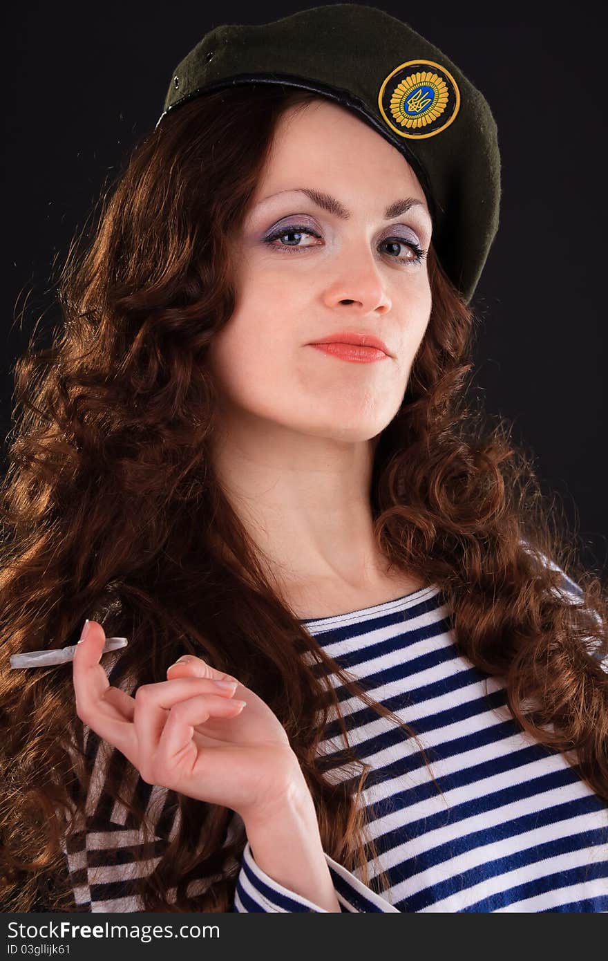 Emotional portrait of a girl in a vest and a military beret. Emotional portrait of a girl in a vest and a military beret