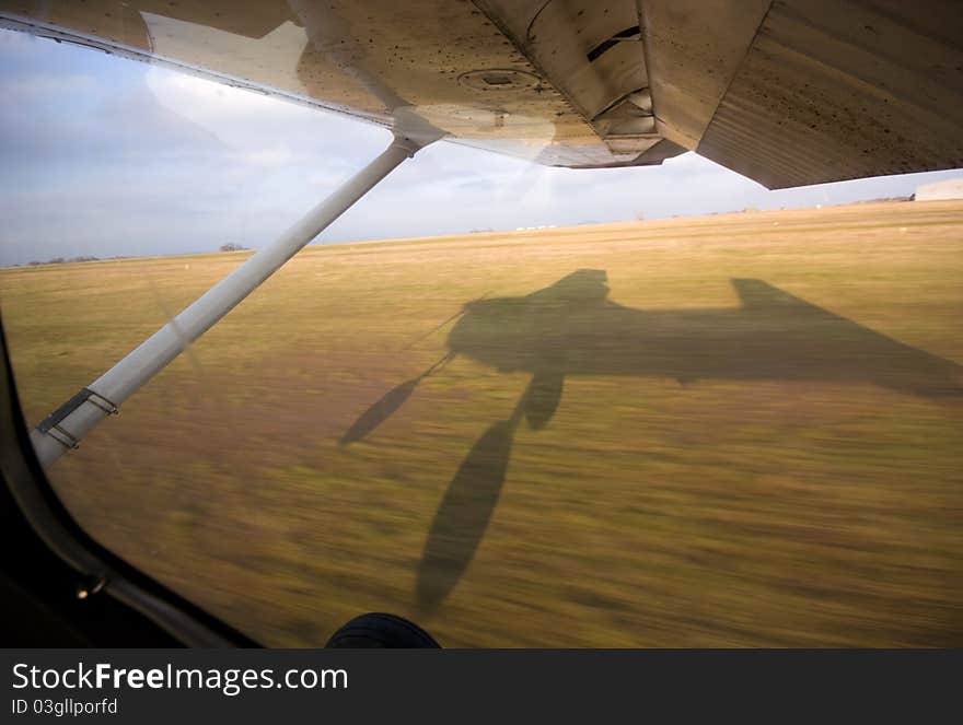 Shadow of a small aircraft while landing. Shadow of a small aircraft while landing
