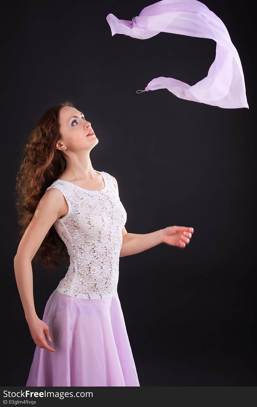 Portrait of beautiful woman in a lilac dress with scarf