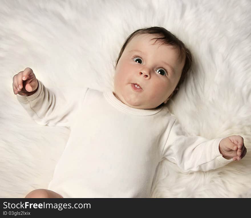 Sweet little baby on white fur. Sweet little baby on white fur