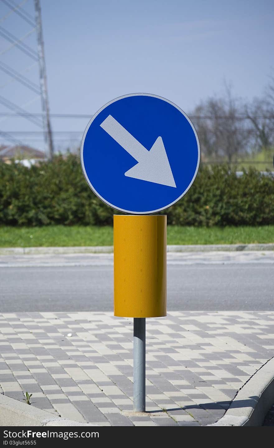 Road Sign In A Sunny Day.